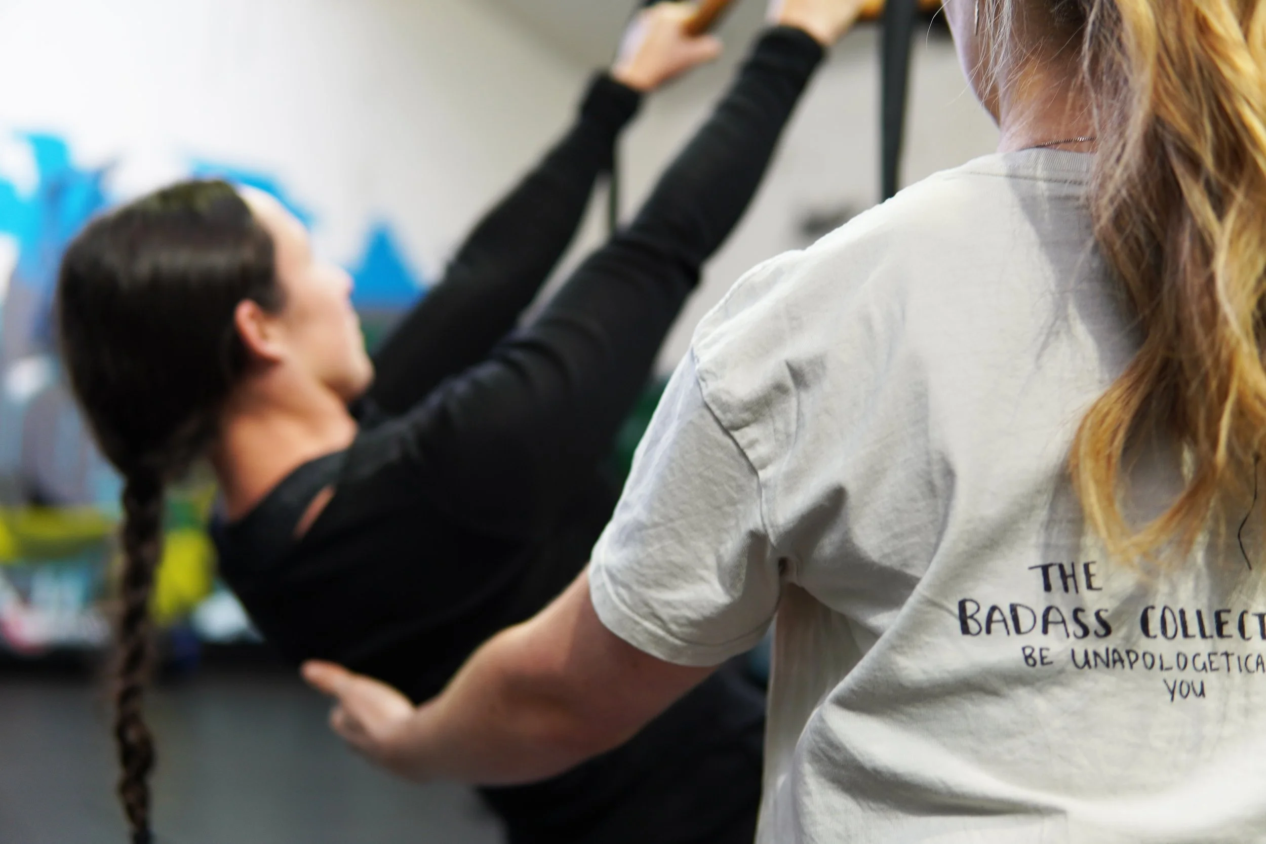 Coach Lydia coaching a client — building a consistent gym routine